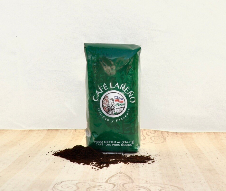 Café Lareño 8 oz package of pure Puerto Rican coffee with ground coffee spilling out