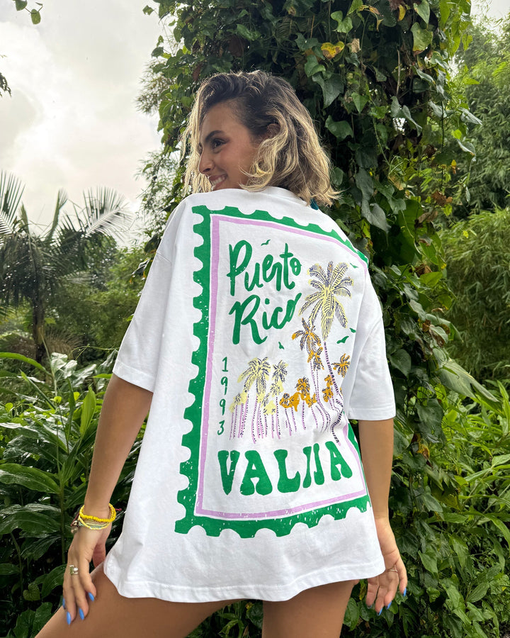 Arte Sello Top handmade white tee featuring a Puerto Rico stamp design with palm trees and vibrant colors