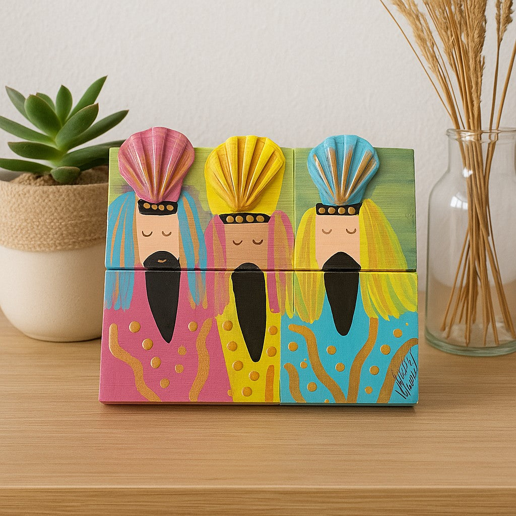 Colorful artisan wooden souvenirs featuring three whimsical figures with vibrant designs