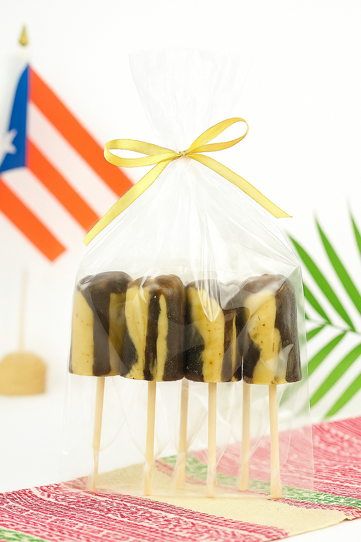 El Artesano Puerto Rican coffee lollipop set wrapped with a gold ribbon and displayed with a Puerto Rican flag