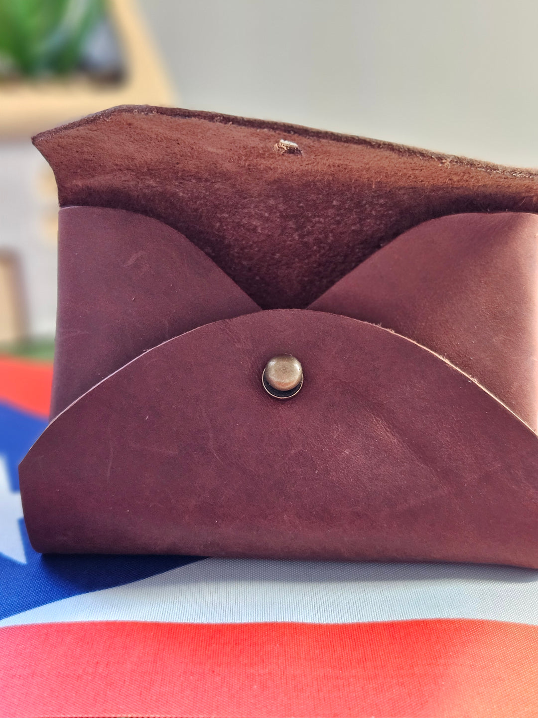 Brown leather pouch gift handcrafted by Atelierry, featuring a stylish fold-over design and snap closure