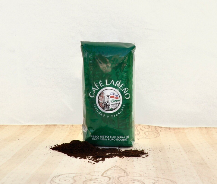 Café Lareño 8 oz package of pure Puerto Rican coffee with ground coffee spilling out