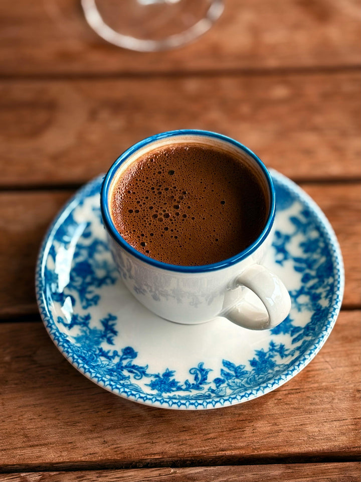 Cup of authentic Puerto Rico coffee served on a decorative blue and white plate