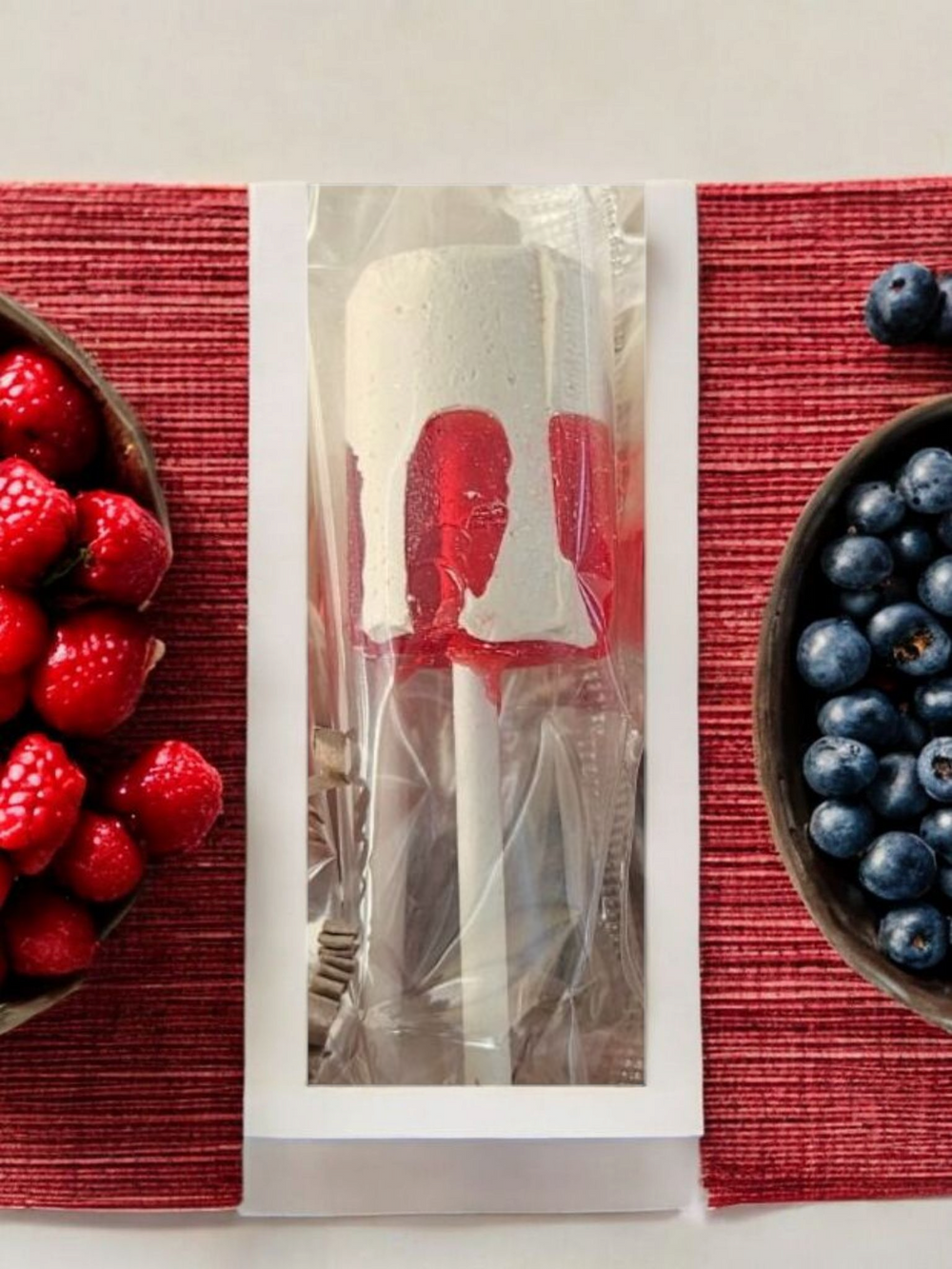 Boricua Gift Shop Coconut strawberry candy on a stick with raspberry and blueberry side decorations