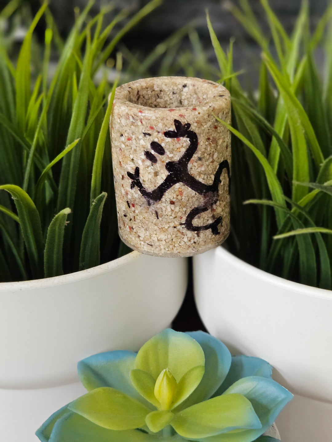 Handcrafted stone cultural shot glass gift featuring a lizard design surrounded by greenery