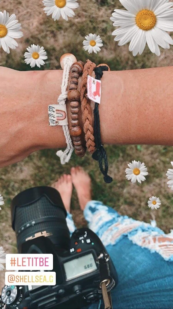 Earth Bands bliss brave beautiful bracelet worn with a camera and floral background