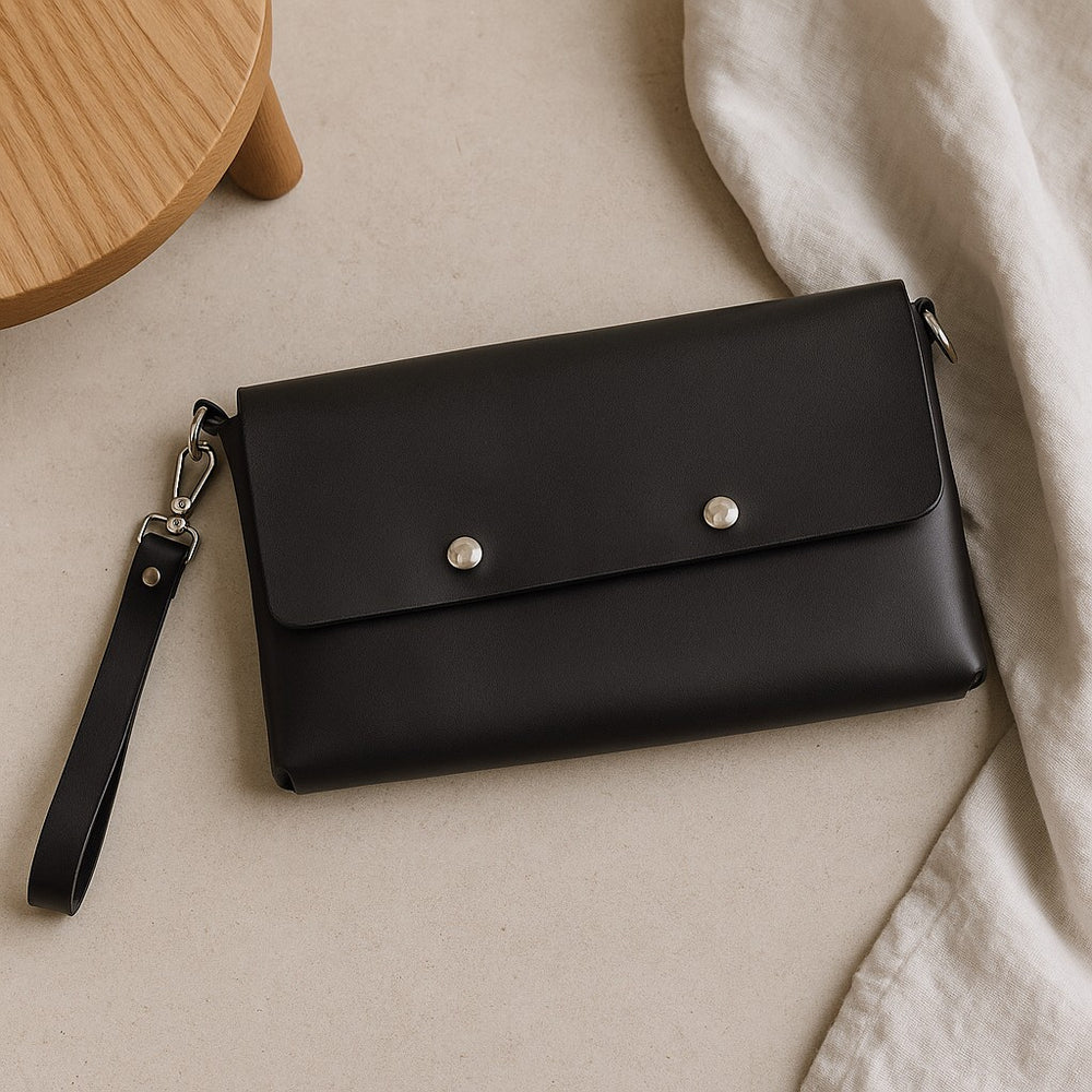 Handmade black leather purse with a sleek design and detachable strap for stylish versatility