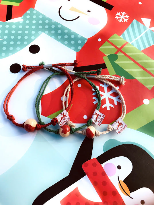 Set of three Earth Bands handmade Christmas Santa gift bracelets with festive colors and charm accents