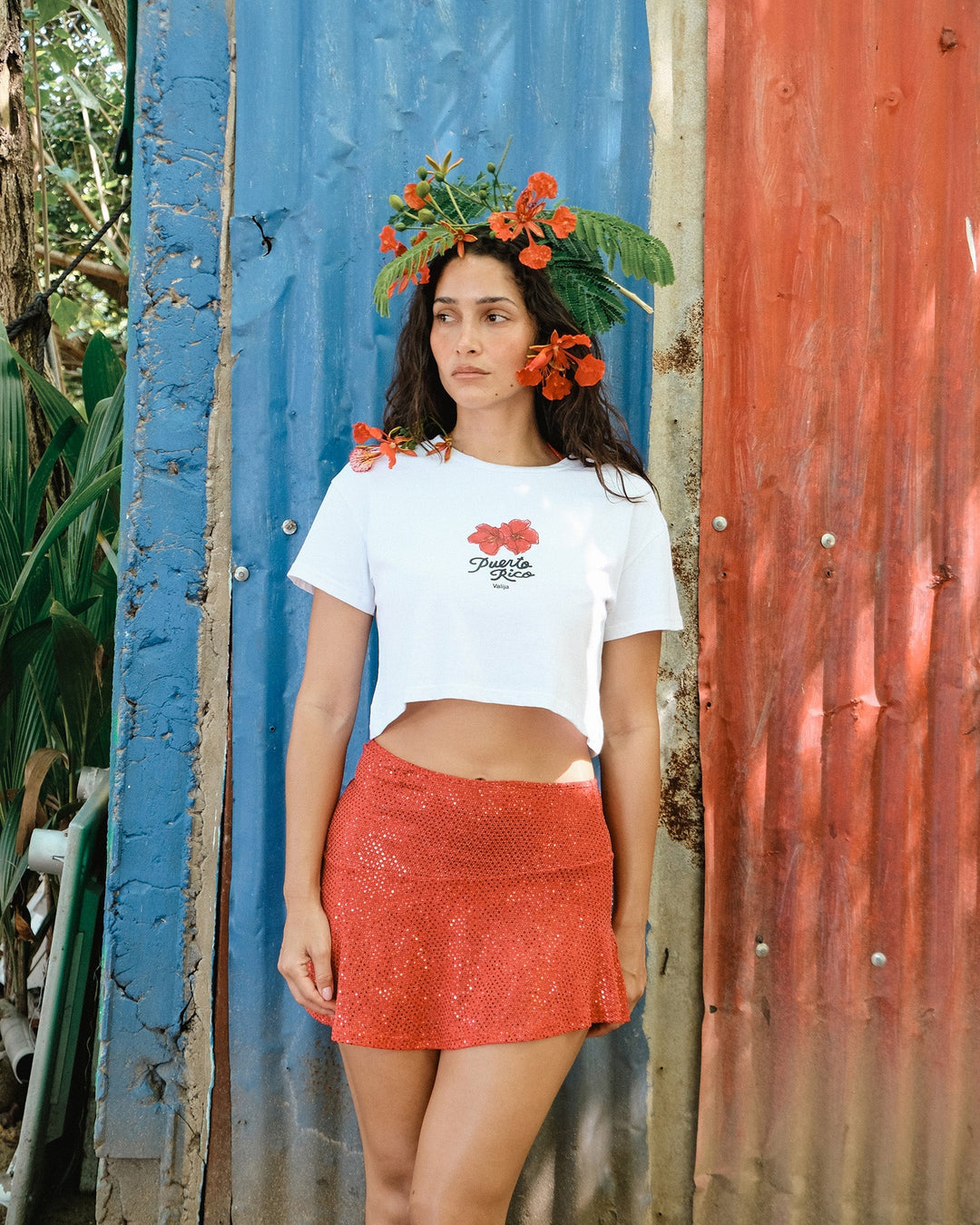La Rincon Maga top for women in white with floral design, styled with a red skirt and tropical backdrop