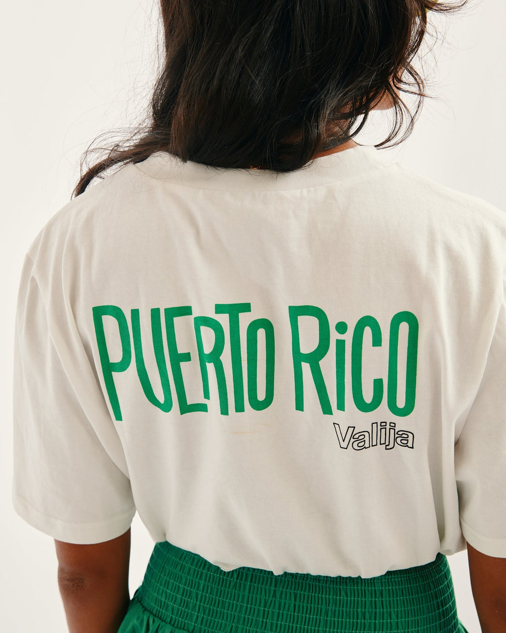 Valija La San Juan Top featuring Puerto Rico graphic in bold green letters on a white tee