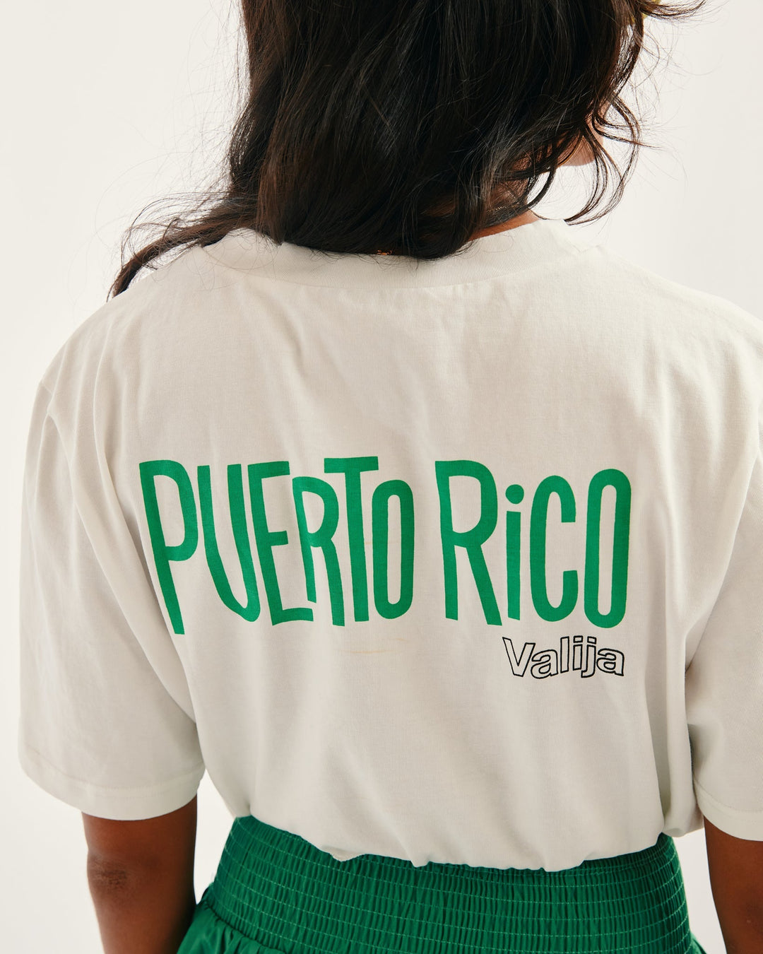 Valija La San Juan Top featuring Puerto Rico graphic in bold green letters on a white tee
