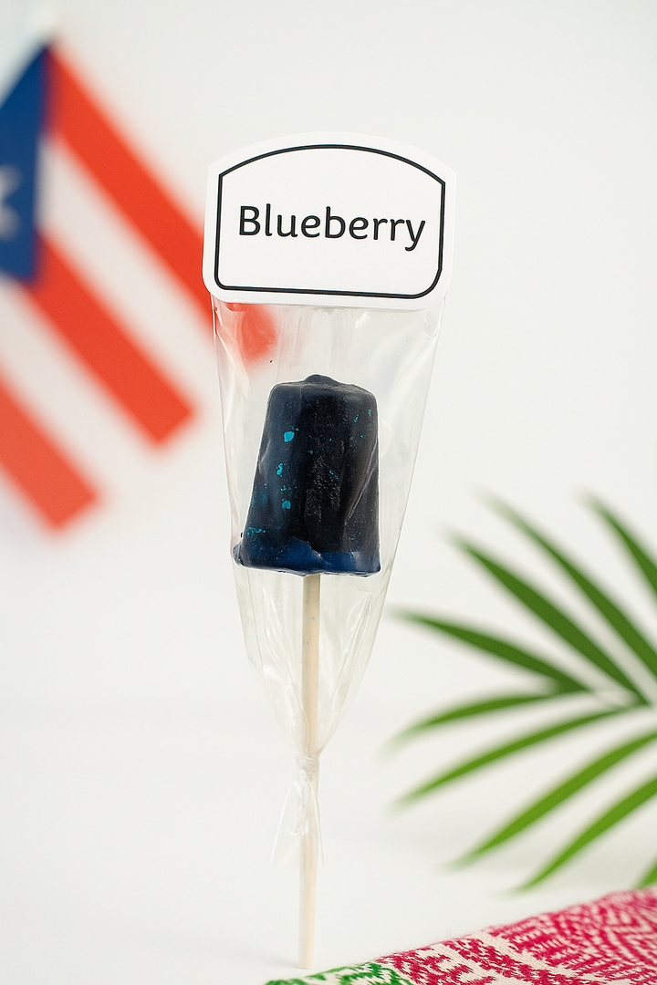 El Artesano Puerto Rican blueberry lollipop wrapped with a label and Puerto Rican flag in background