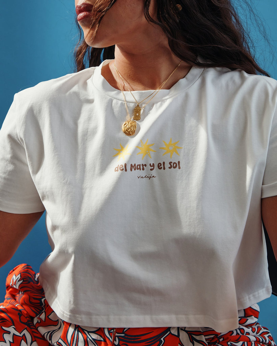 Valija Puerto Rican crop top in white featuring sun designs and a relaxed fit