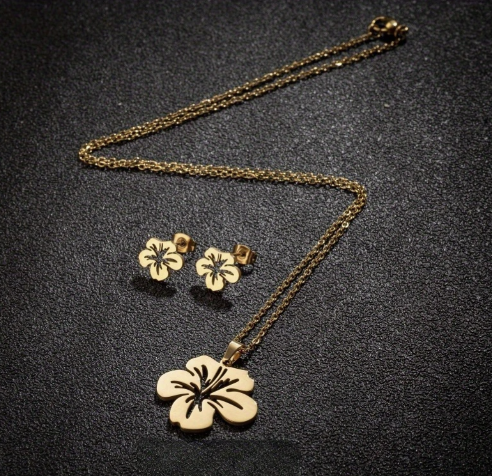 Gold Puerto Rican floral jewelry set featuring a pendant necklace and matching earrings