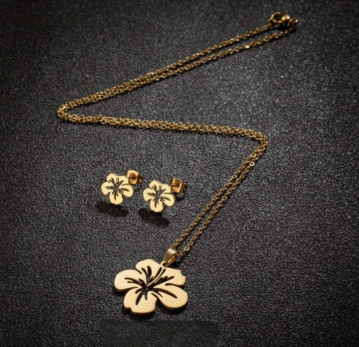 Gold Puerto Rican floral jewelry set featuring a pendant necklace and matching earrings