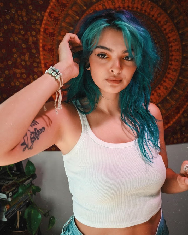 Stylish woman wearing a Puerto Rican handmade bracelet, showcasing vibrant colors and unique design.