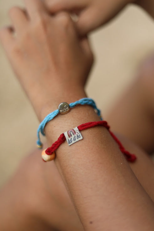 Earth Bands Puerto Rican happiness bracelet in red and blue showcasing a unique design on a wrist