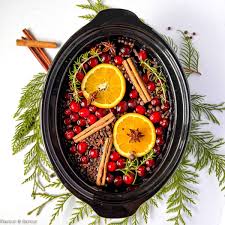 Puerto Rican holiday simmer pot jar filled with cranberries, orange slices, and spices for festive aroma