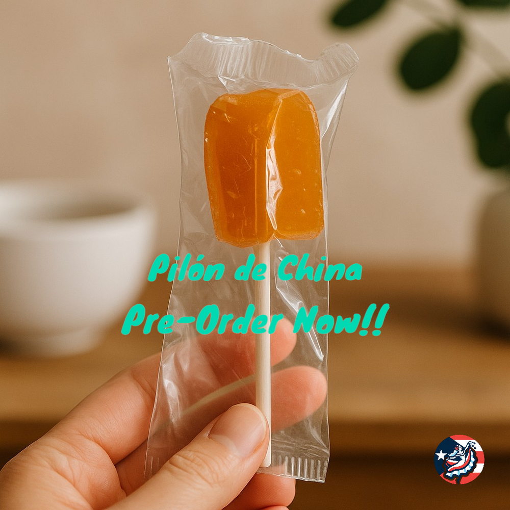 Hand holding a Puerto Rican orange lollipop wrapped in clear packaging for a delicious treat