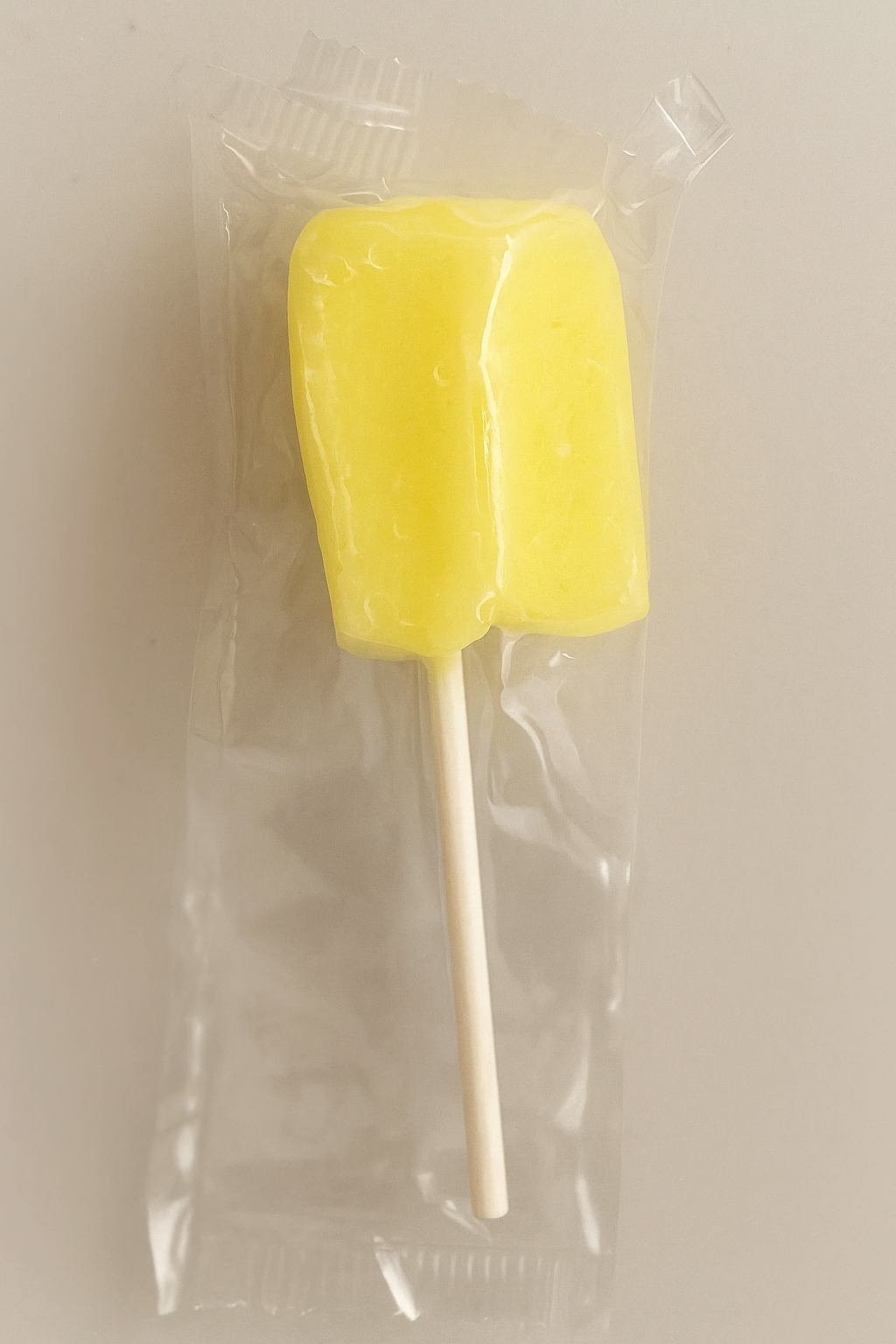 Tipica Artesanal Puerto Rican pineapple lollipop in yellow color with a stick for easy enjoyment
