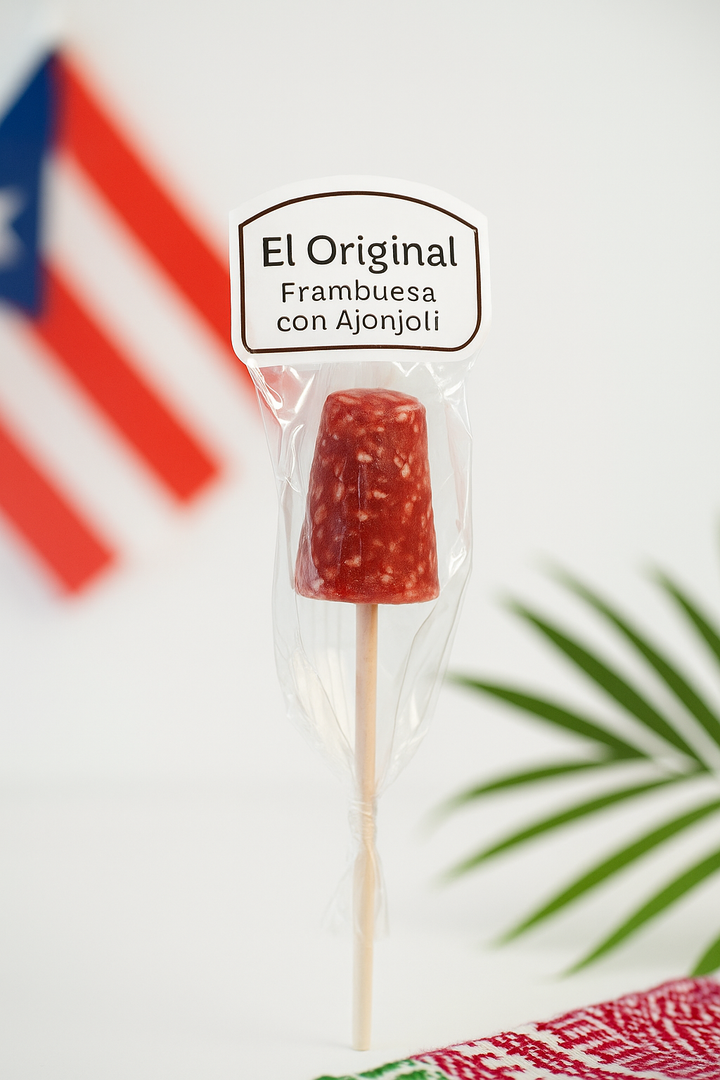 El Artesano Puerto Rican raspberry sesame lollipop with red candy and sesame seeds on a stick