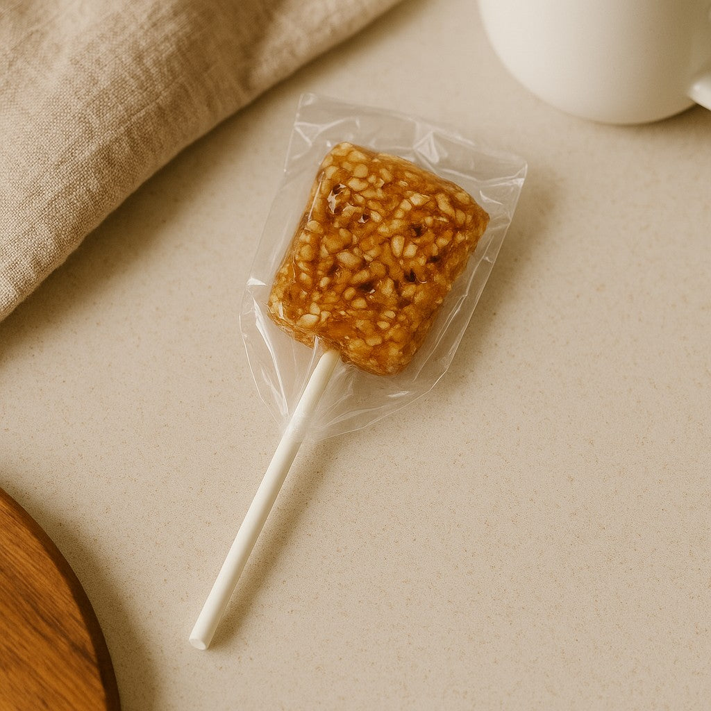 Puerto Rican sesame lollipop in clear packaging on a light surface