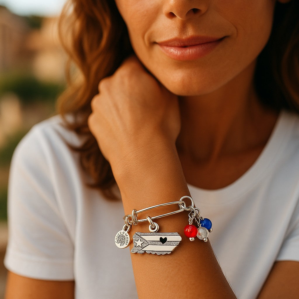 Puerto Rico charm bracelet with colorful beads and silver charms on a woman's wrist