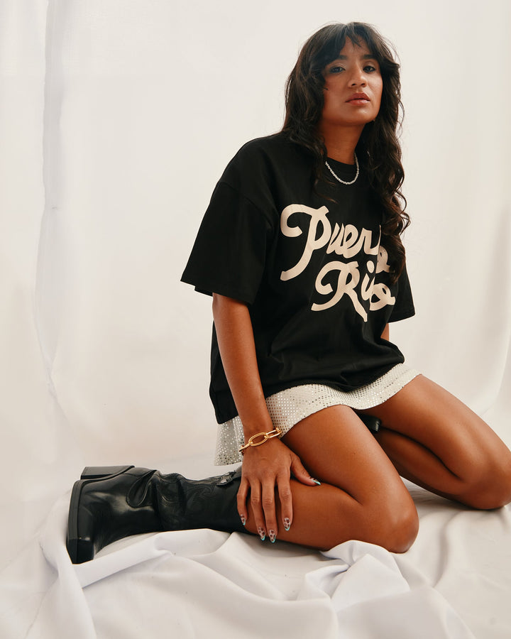 Puerto Rico graphic t-shirt styled on model with casual outfit and knee-high boots