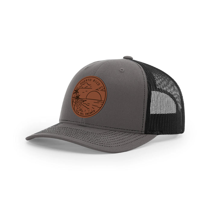 Puerto Rico leather patch hat featuring a scenic sunset design on a gray trucker cap