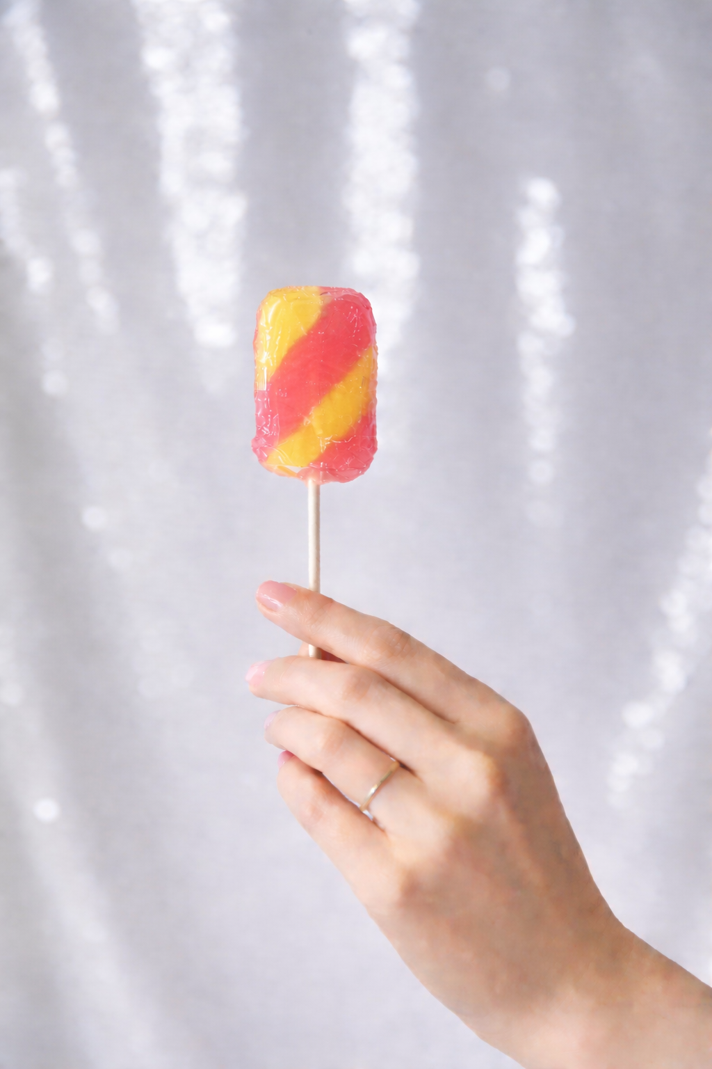 Traditional Puerto Rican lollipop with vibrant red and yellow swirls