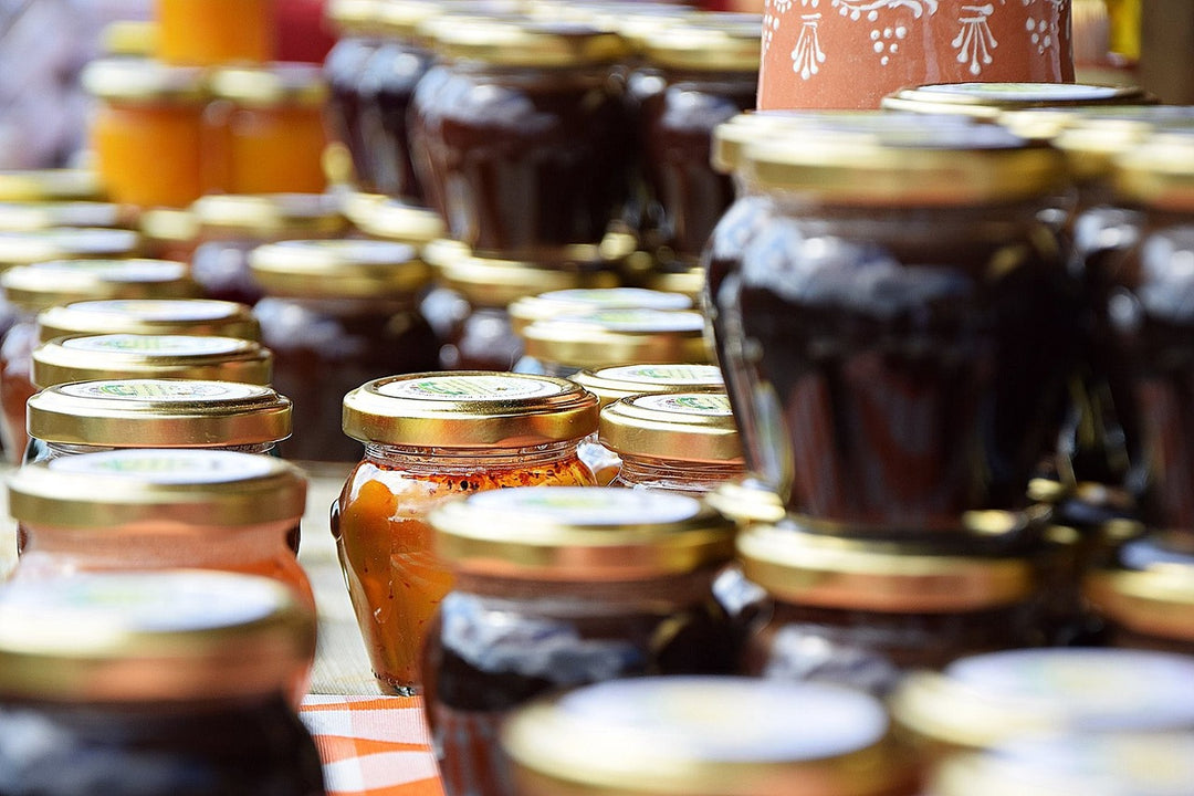 Assorted jars of Apiarios Caraballo turmeric cinnamon ginger jelly showcasing vibrant colors and rich textures