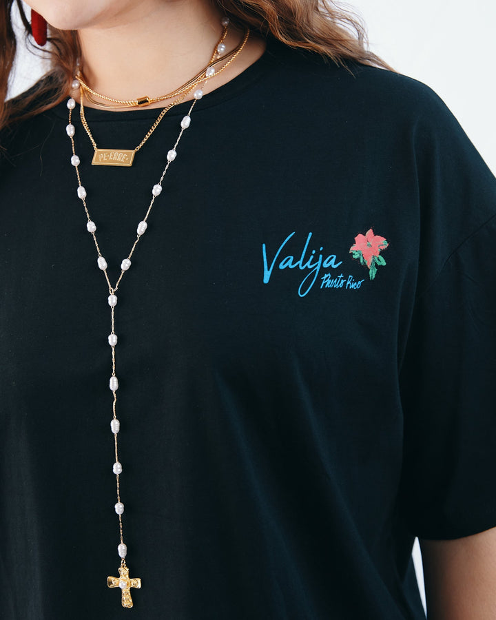 Valija abuelita graphic top in black featuring floral design and layered necklaces