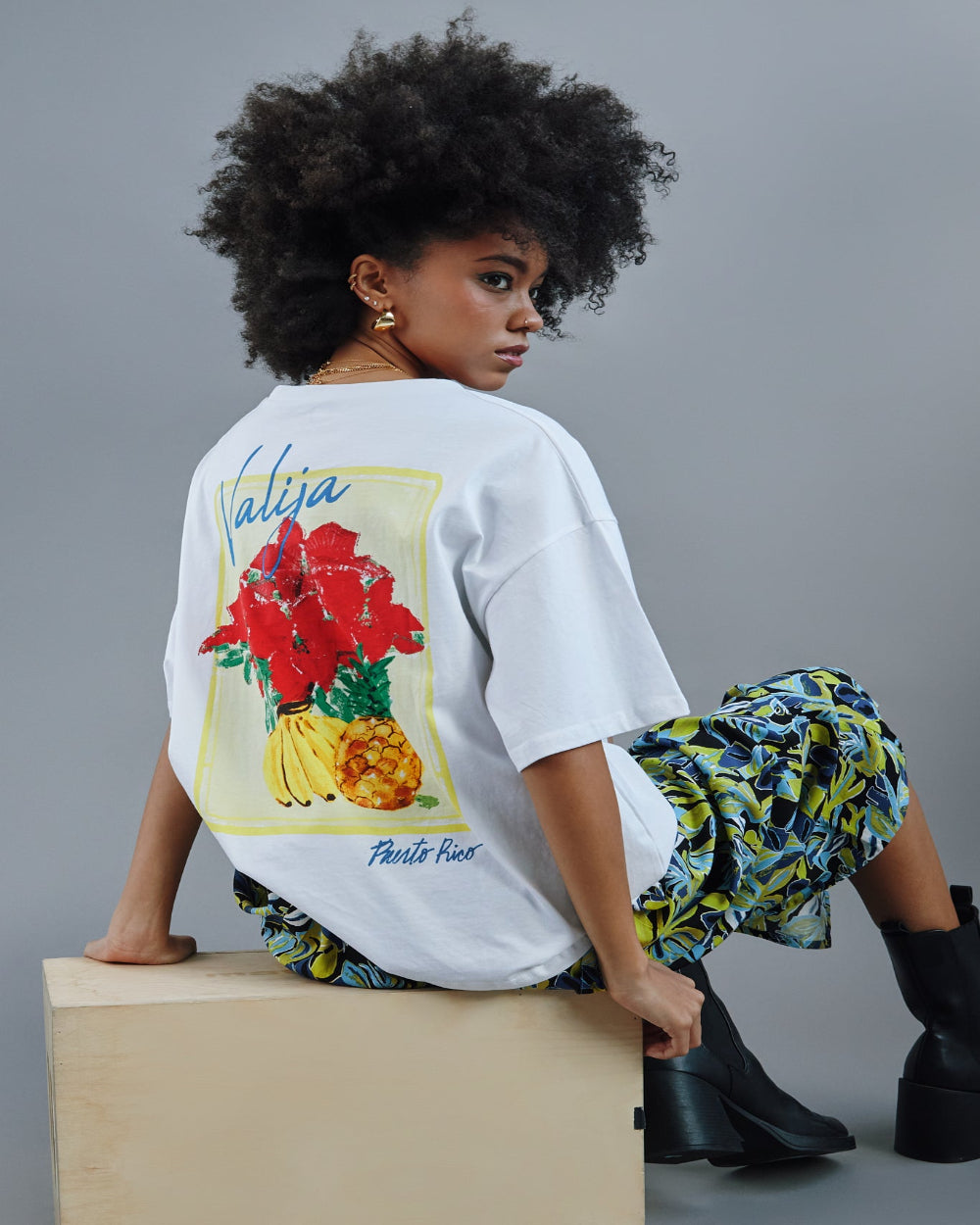 Valija abuelita graphic top featuring vibrant floral and fruit design on a white background