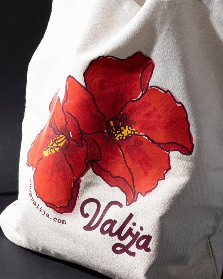 Flor de Maga tote bag by Valija featuring a vibrant red flower design on a cream background