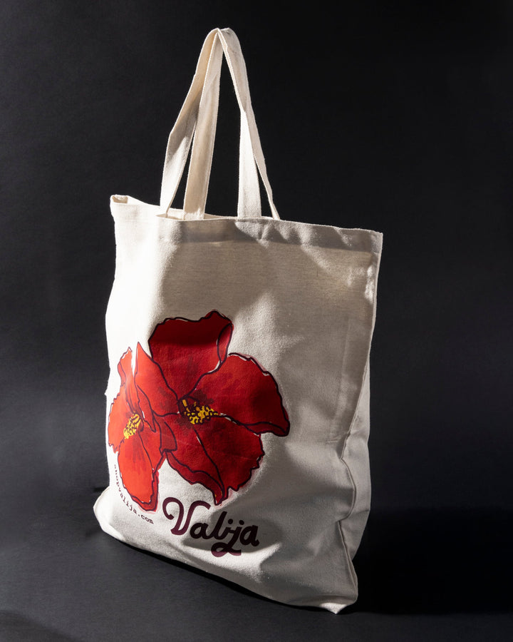 Valija Flor de Maga tote bag with vibrant red flower design on a natural canvas background