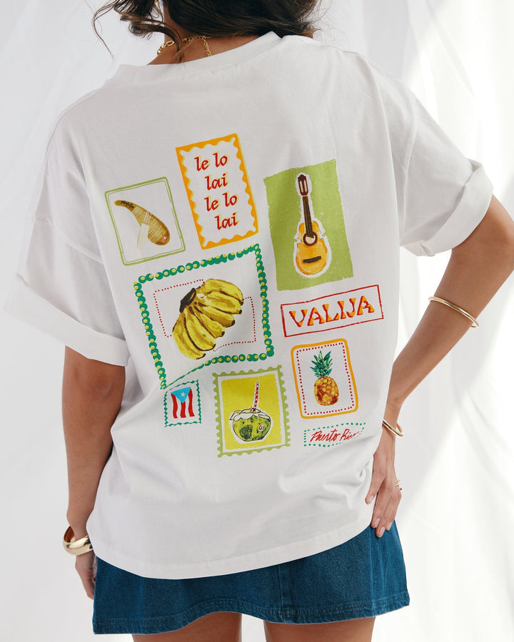 Valija Parranda graphic t-shirt featuring colorful prints including musical instruments and tropical fruits