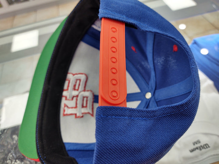 Peligro Sports snapback hat in blue with adjustable strap and colorful design