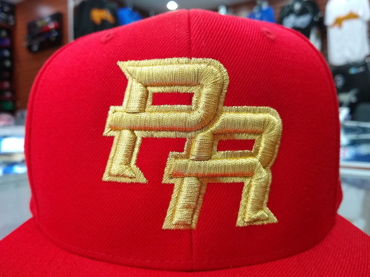 Peligro Sports red snapback hat with gold PR logo for Puerto Rico fans