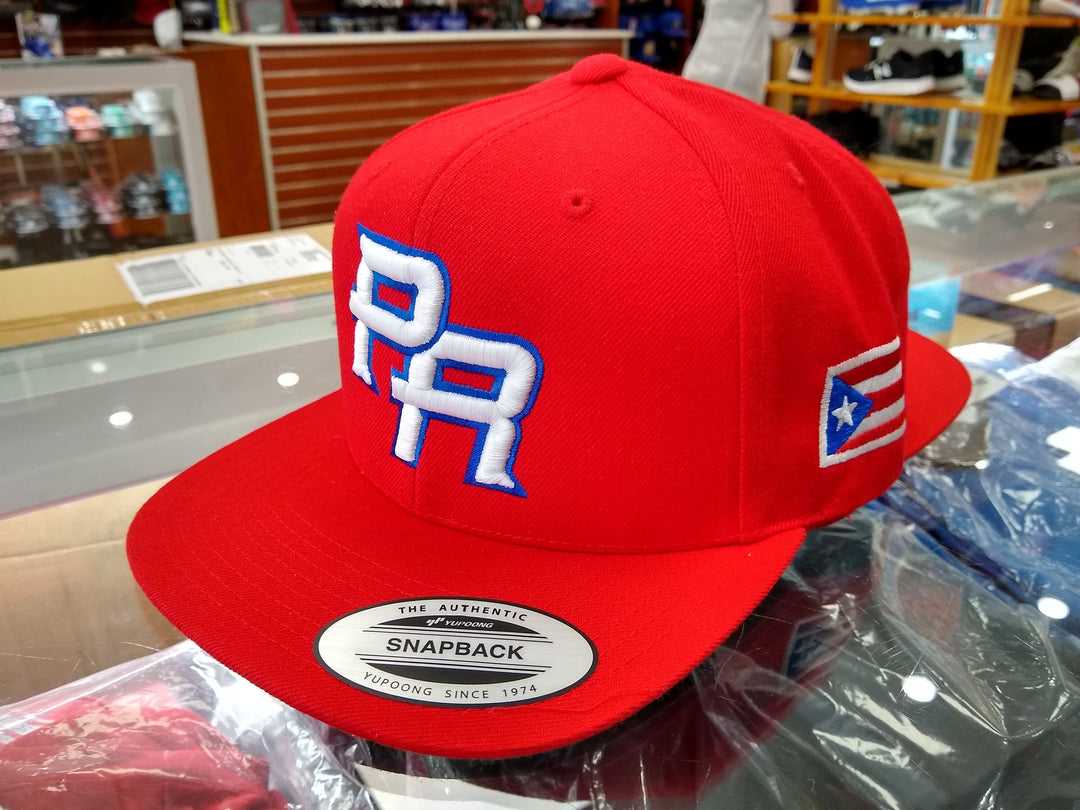 Red snapback hat featuring PR and Puerto Rican flag design