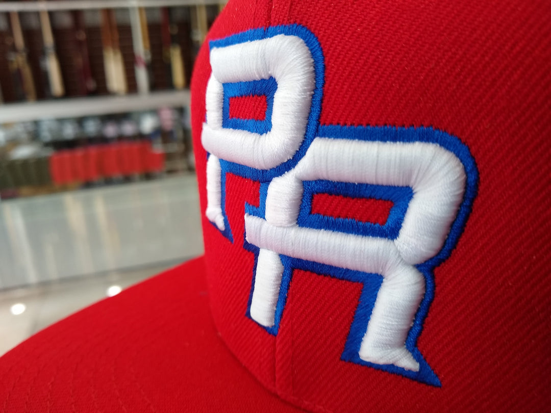 Red snapback hat with PR embroidery representing Puerto Rico